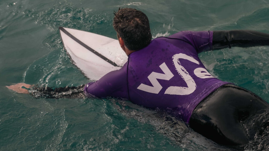 A surfing paddeling out on day 3 of Blue Earth Summit at The Wave in Bristol.